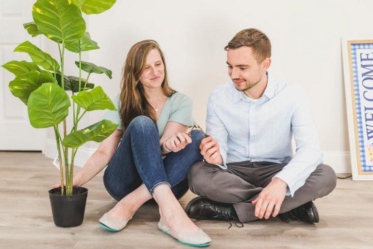 man and woman sitting on the floor while holding keys